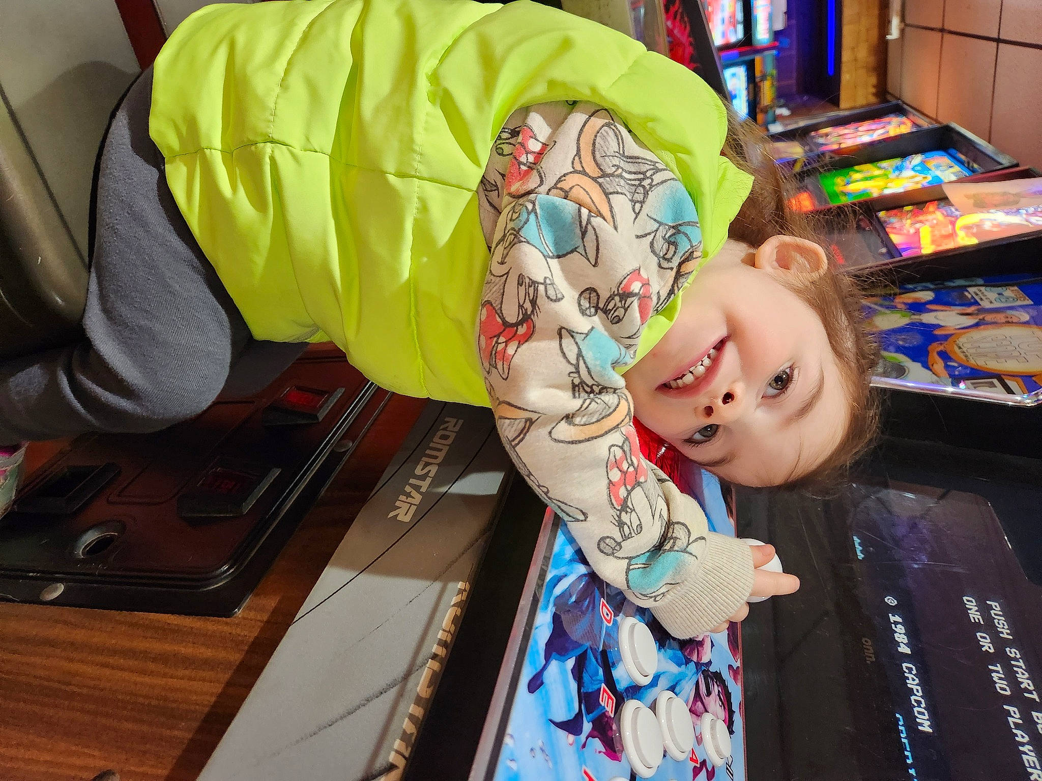 Ryder is registered to the contest to win money with this photo: child, costume, fun, pattern, person, room, shelf, sitting, t_shirt, table, tattoo, toddler, visual_arts