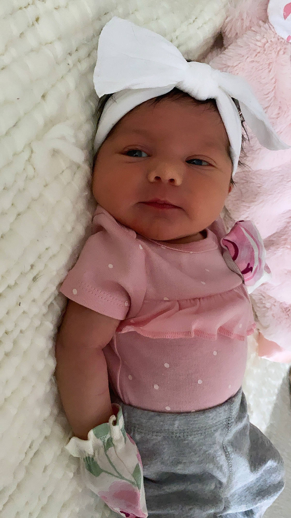 Capri is registered to the contest to win money with this photo: baby, baby_toddler_clothing, cap, cheek, child, comfort, eye, eyebrow, face, happy, headwear, human_body, iris, lip, nose, person, pink, skin, sleeve, smile