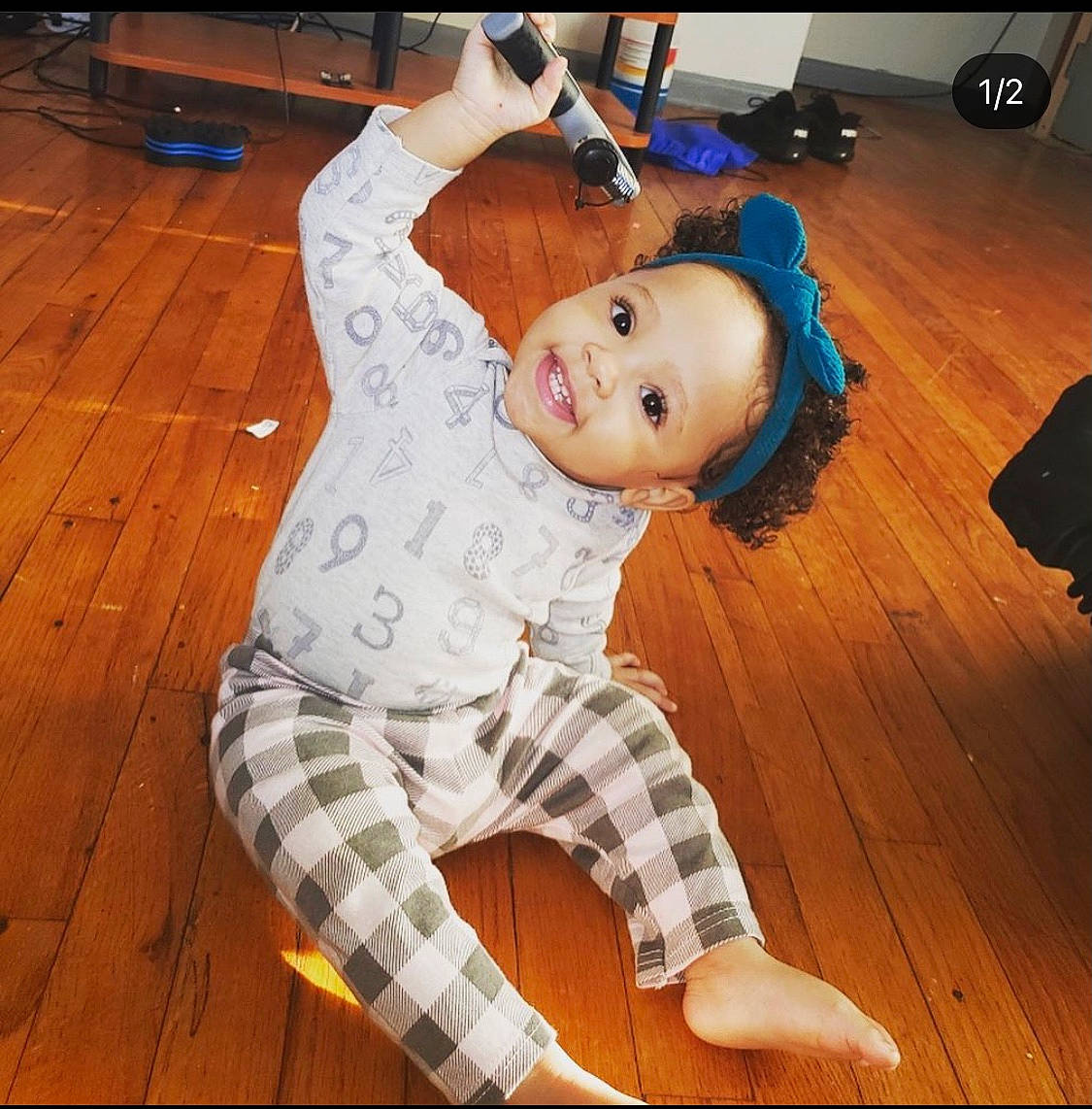 Emeri joined the competition — help win amazing prizes! elbow, flash_photography, floor, flooring, fun, happy, hardwood, human_leg, joy, knee, laminate_flooring, leisure, person, plaid, sitting, smile, sportswear, thigh, toddler, varnish