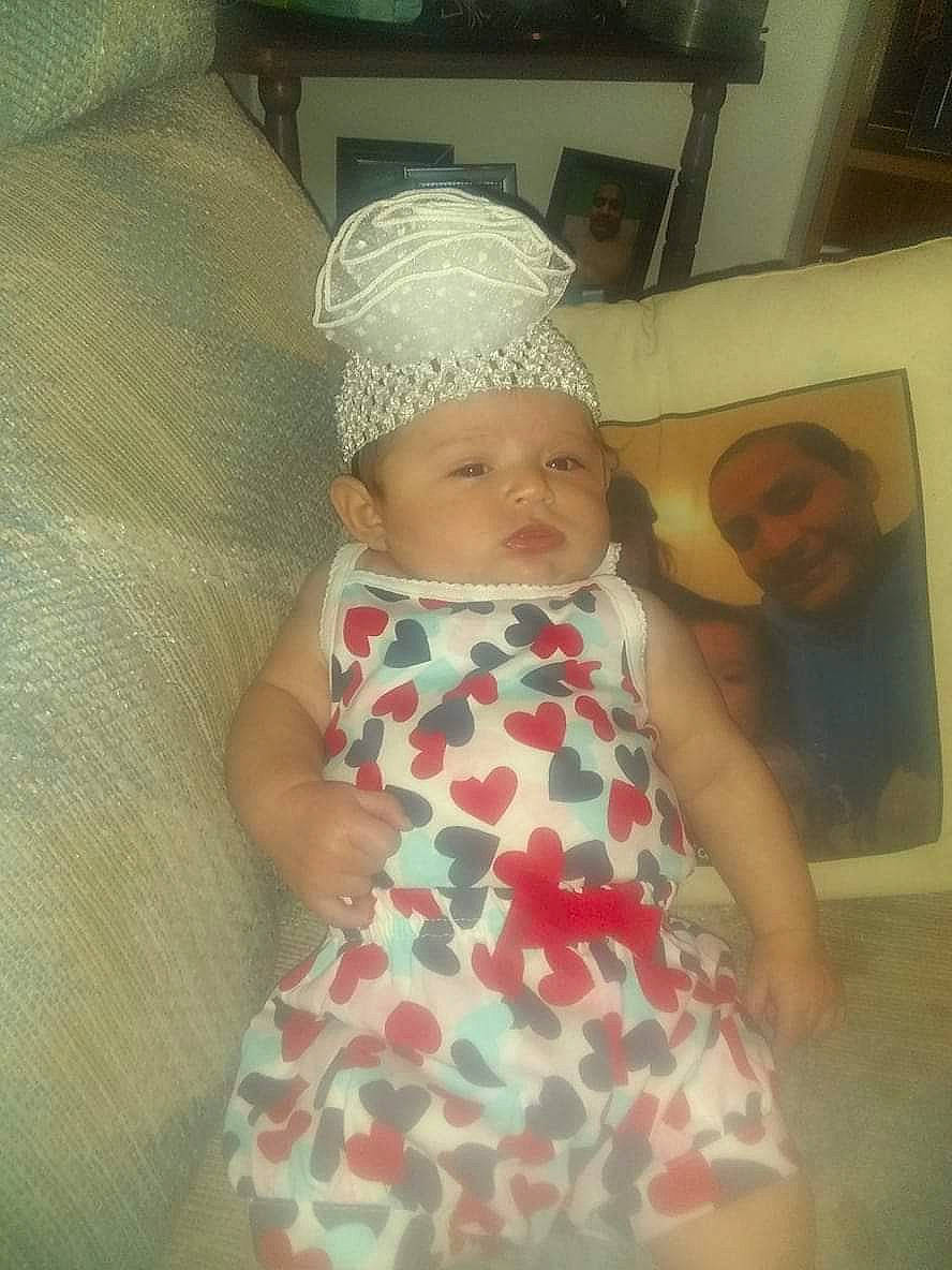 Memory is registered to the contest to win money with this photo: baby, baby_products, baby_sleeping, baby_toddler_clothing, cap, child, comfort, day_dress, eye, fashion_accessory, head, headband, headwear, iris, joy, linens, mouth, pattern, person, room