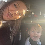 Romey joined the competition — help win amazing prizes! woman, baby, car, car_seat, sunlight, seatbelt, smiling, happy, portrait, child, interior, casual_clothing, daylight, person, travel, seat, transportation, family, young_child, playful