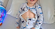 Tysen joined the competition — help win amazing prizes! bed, bedroom, blue, child, face, hair_style, happy, healthcare, hospital_bed, indoor, medical_tape, onesie, pajamas, patient, pillow, playful, smiling, tongue_out, toy, young_child