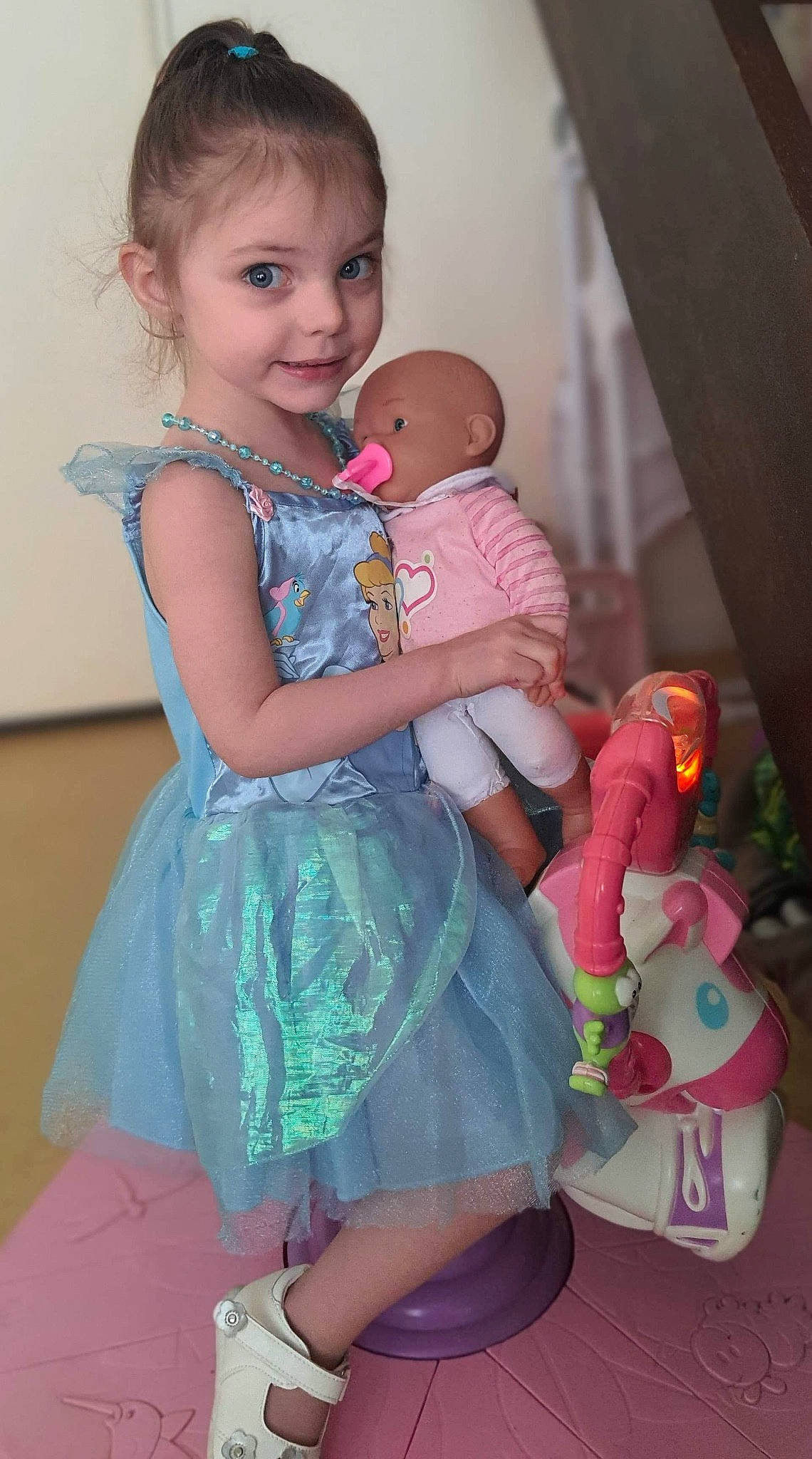 Tyana participe au concours pour gagner de l'argent avec cette photo : baby, baby_toddler_clothing, child, dress, event, fashion_design, flash_photography, formal_wear, fun, happy, iris, jewellery, joy, magenta, person, pink, sitting, skin, smile, textile