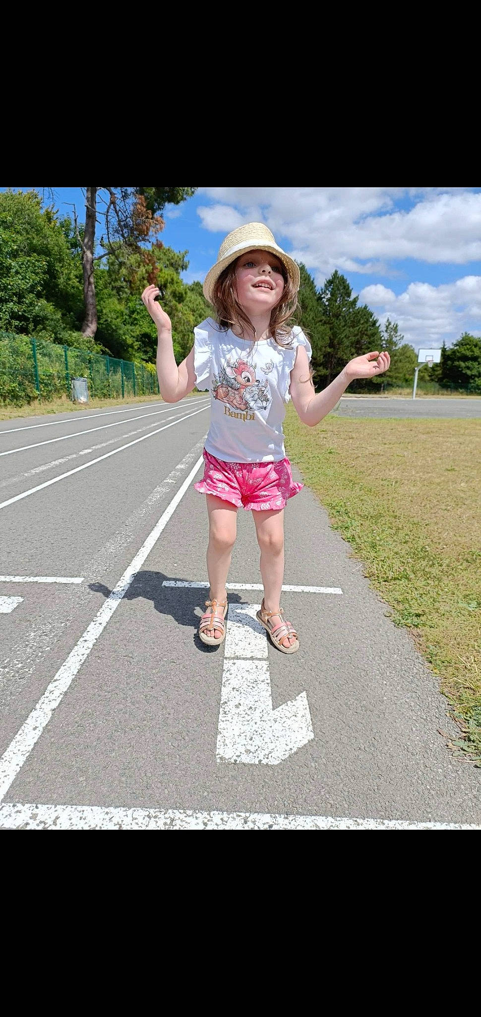 Tyana participe au concours pour gagner de l'argent avec cette photo : asphalt, cloud, grass, happy, hat, headwear, human_leg, leisure, pattern, pedestrian, people_in_nature, person, pink, plant, recreation, road, road_surface, sky, sun_hat, toddler