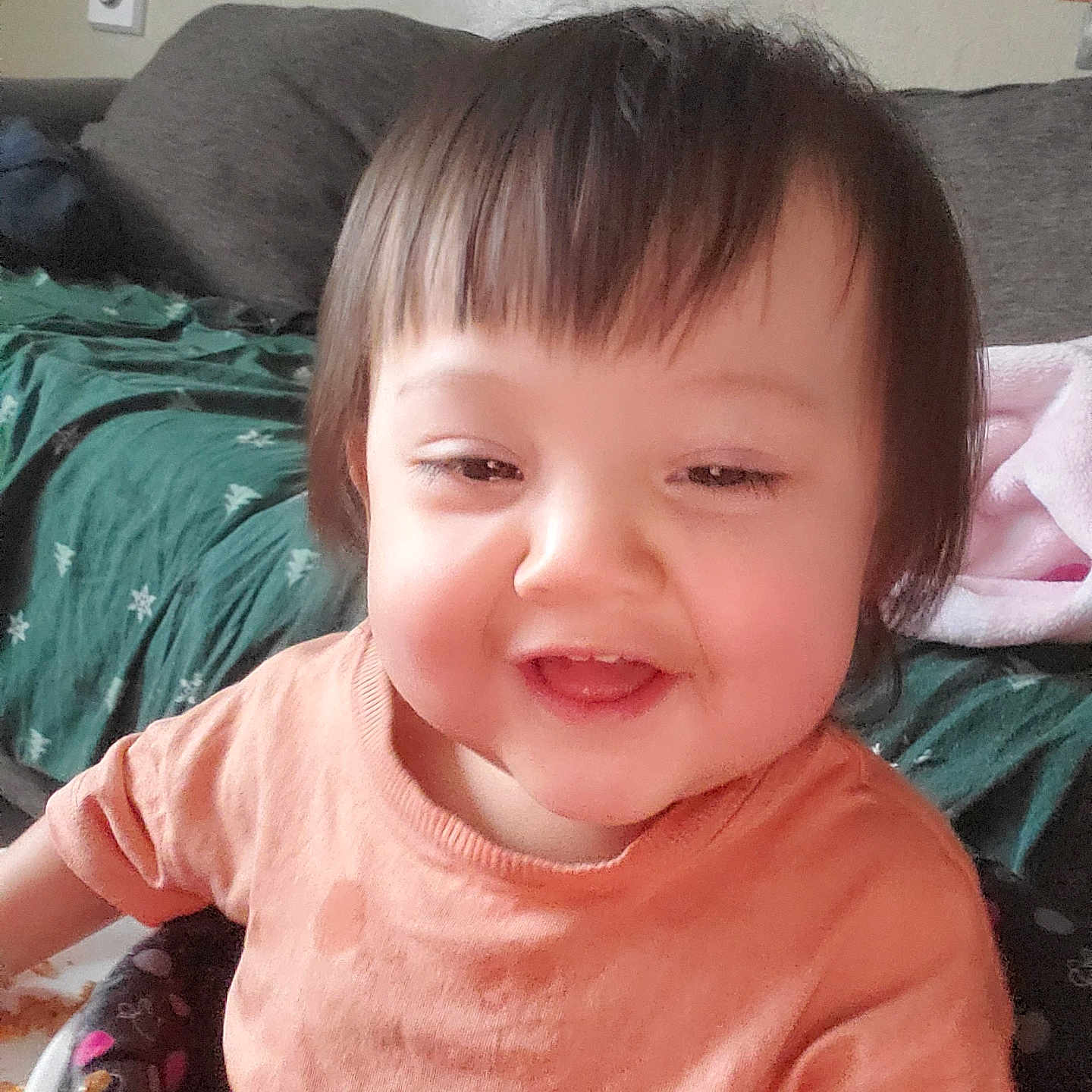 Olivia is registered to the contest to win money with this photo: baby, bed, bedroom, clothing, couch, cushion, face, furniture, happy, head, homedecor, indoors, laughing, person, photoframe, photography, portrait, room, smile, t_shirt