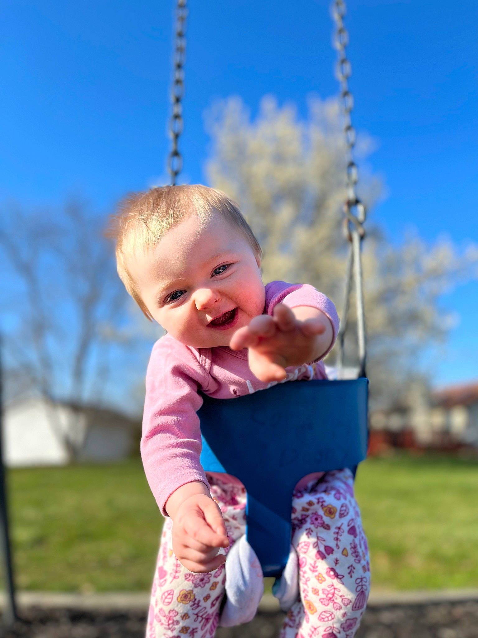 Savannah joined the competition — help win amazing prizes! azure, baby, baby_toddler_clothing, child, city, facial_expression, fun, grass, happy, human_settlement, leisure, people_in_nature, person, skin, sky, sleeve, smile, standing, summer, swing