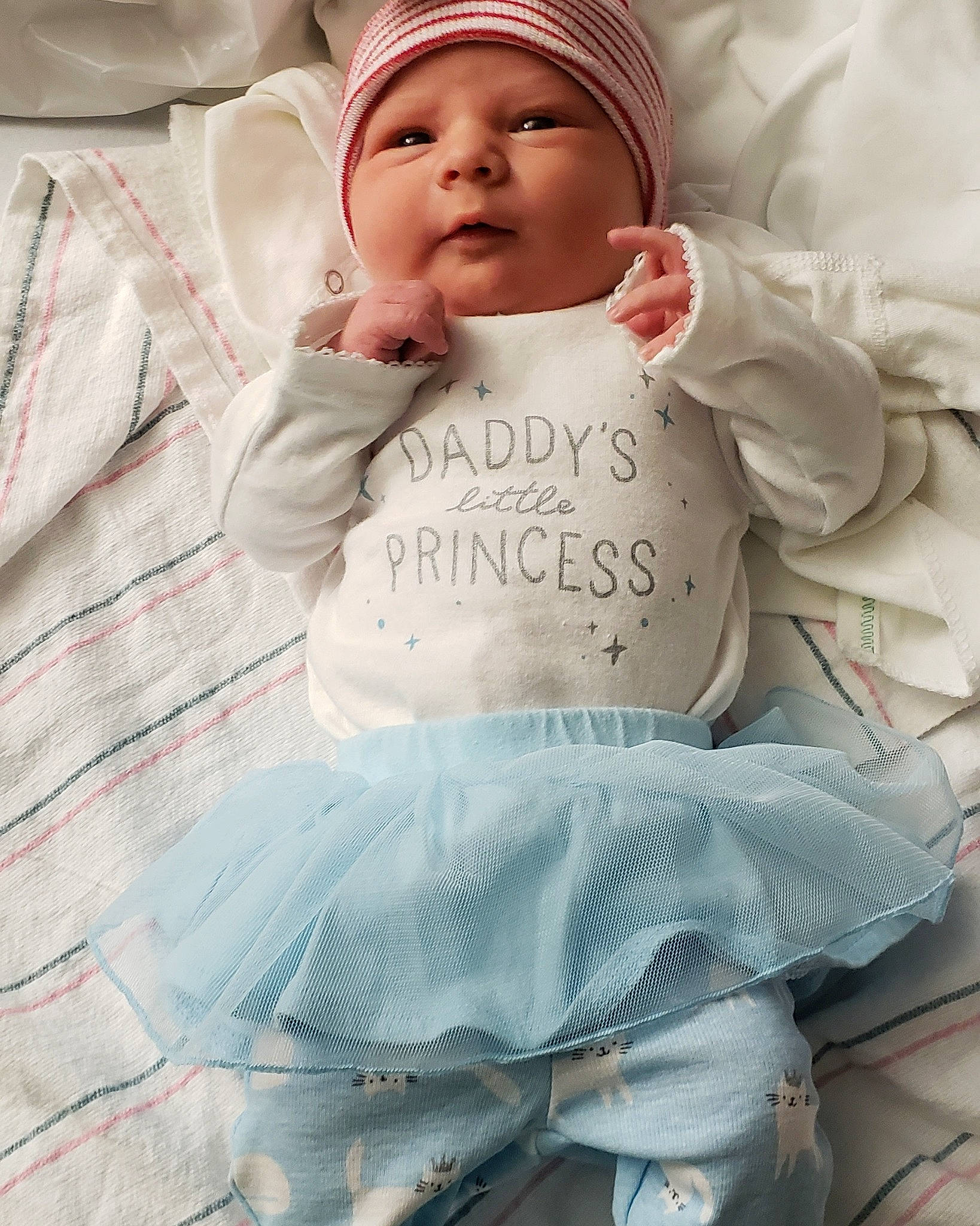 Sara is registered to the contest to win money with this photo: baby_products, child, girl, hair_accessory, headwear, infant, material, outerwear, person, product, textile, toddler