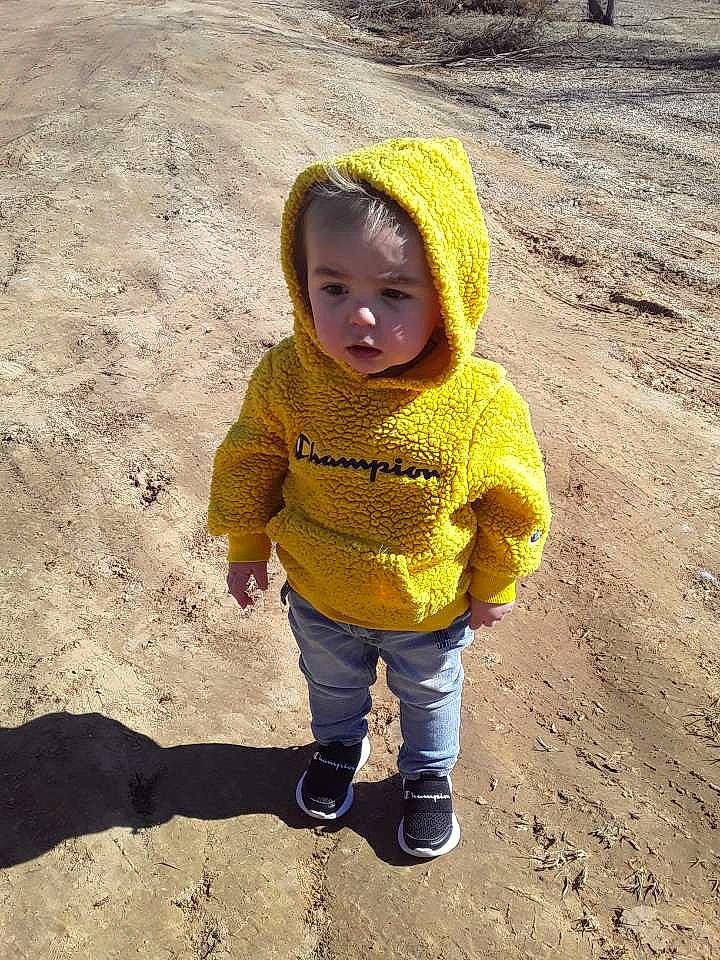 Björn is registered to the contest to win money with this photo: baby, baby_toddler_clothing, body_of_water, cap, eye, fun, grass, head, jeans, landscape, mammal, people_in_nature, person, play, sand, shadow, sleeve, soil, toddler, tree