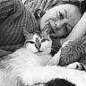 Markisa is registered to the contest to win money with this photo: person, cat, black_and_white, cozy, blanket, lying_down, relaxed, pet, animal, portrait, close_up, furry, indoor, smiling, cuddling, face, whiskers, cute, companion, resting