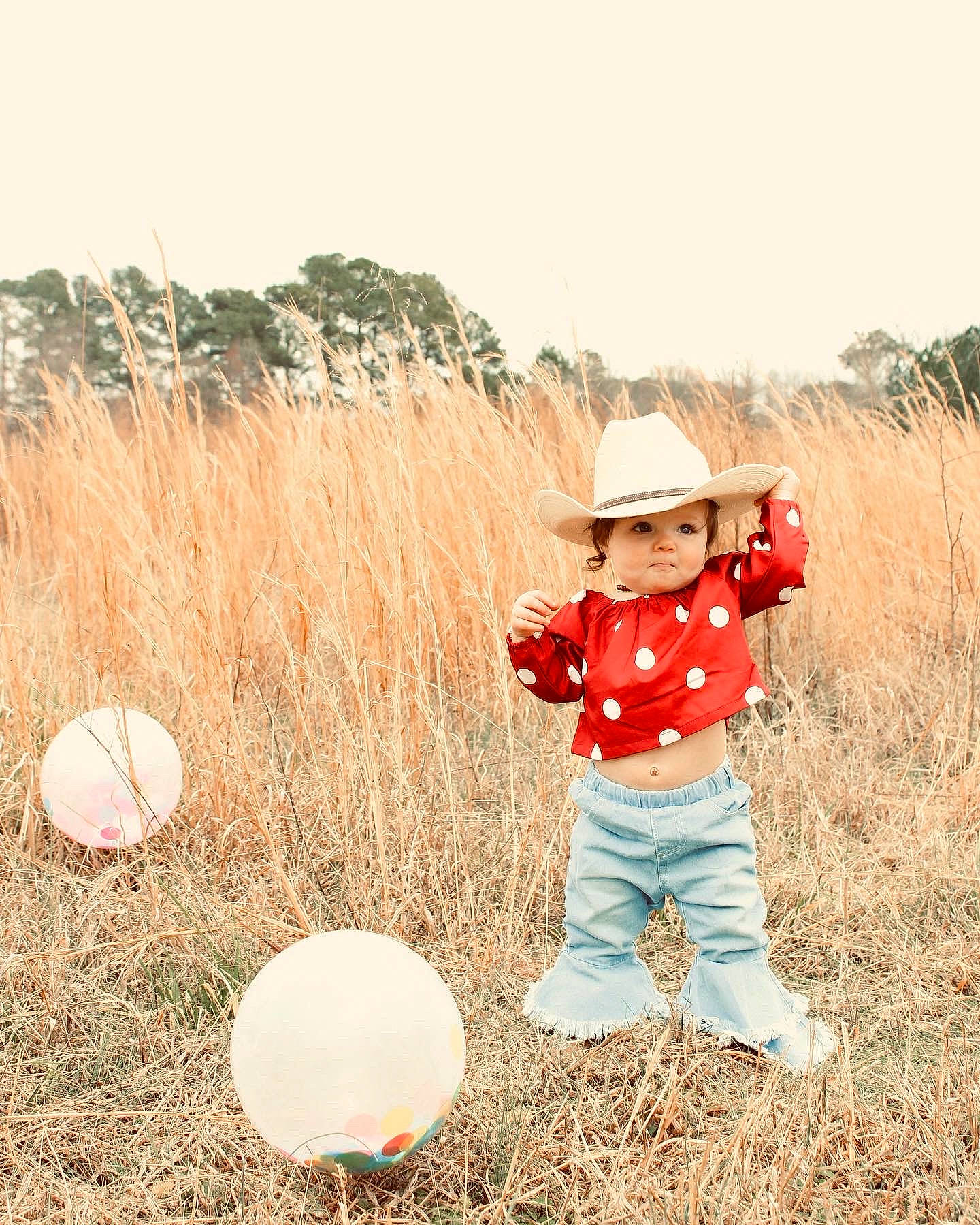 Blakely joined the competition — help win amazing prizes! agriculture, baby_toddler_clothing, field, fun, grass, grass_family, grassland, happy, hat, headwear, landscape, meadow, people_in_nature, person, plant, prairie, recreation, sky, soil, sun_hat