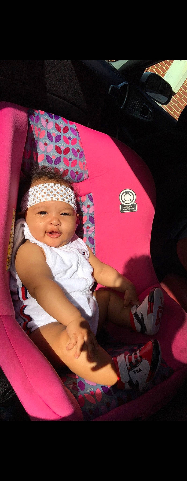Atienna is registered to the contest to win money with this photo: auto_part, baby, baby_carriage, baby_products, baby_toddler_clothing, cap, car_seat, child, comfort, fun, happy, hat, headwear, lap, magenta, person, pink, product, sitting, smile