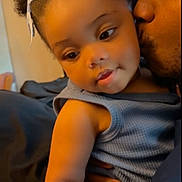 Malaya is registered to the contest to win money with this photo: baby, child, father, kiss, love, affection, curly_hair, bow, blue_outfit, indoor, warm_light, close_up, skin, person, family, holding, cute, toddler, portrait, affectionate