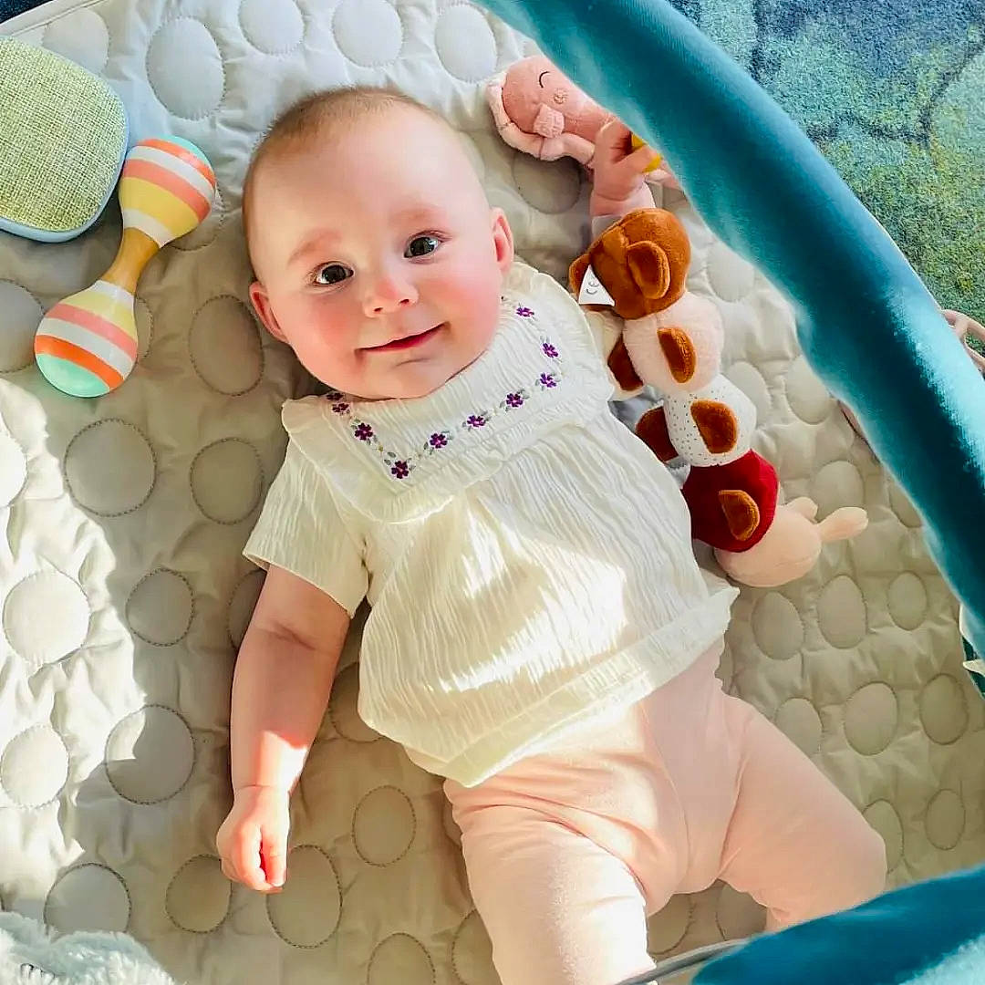 Julia participe au concours pour gagner de l'argent avec cette photo : baby, baby_products, baby_safety, baby_sleeping, baby_toddler_clothing, child, comfort, eye, face, happy, head, joy, linens, pattern, person, pink, product, sleeve, smile, textile