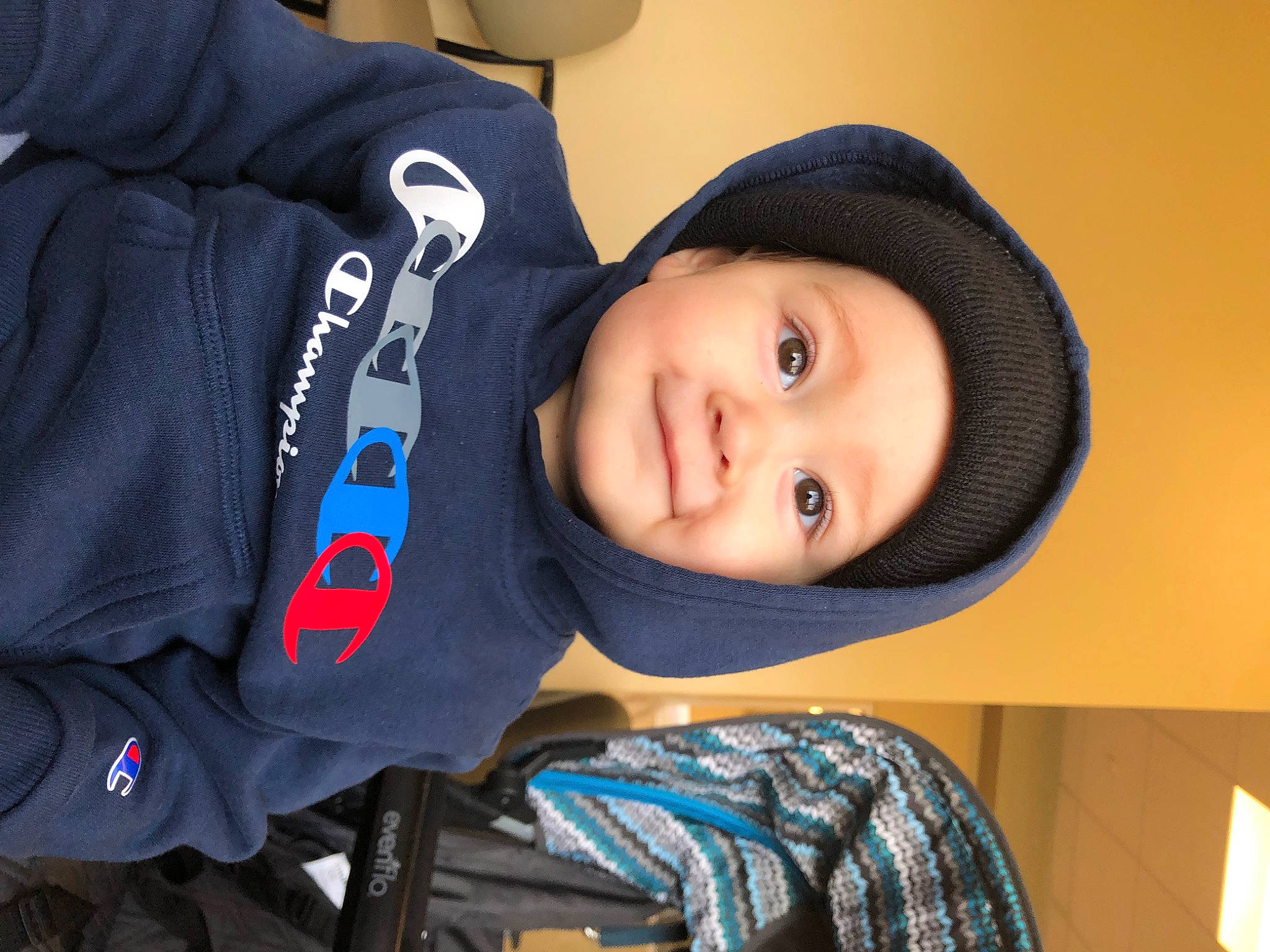 Kai joined the competition — help win amazing prizes! cap, cheek, child, comfort, cool, electric_blue, face, fashion_accessory, happy, hat, headwear, hood, jacket, outerwear, person, polar_fleece, sitting, sleeve, smile, toddler