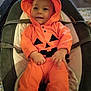 Matthew participe au concours pour gagner de l'argent avec cette photo : baby, baby_seat, child, clothing, costume, cushion, cute, halloween, happy, holiday, hood, indoors, infant, orange_clothing, person, portrait, pumpkin_costume, seat_belt, smiling, young_child