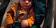 Matthew participe au concours pour gagner de l'argent avec cette photo : baby, baby_seat, blanket, child, comfort, cozy, expression, face, floor, green_blanket, indoor, infant, looking_at_camera, orange_shirt, person, portrait, seated, straps, wooden_floor, young_child