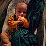 Matthew participe au concours pour gagner de l'argent avec cette photo : baby, baby_seat, blanket, child, comfort, cozy, cushion, face, foot, green_blanket, hand, indoors, infant, orange_clothing, person, portrait, seat, sleepy, soft_lighting, young_child
