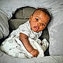 baby, blanket, cushion, soft, infant, curious, face, child, indoors, cozy, comfortable, clothing, expression, portrait, sitting, cute, skin, head, young, rest