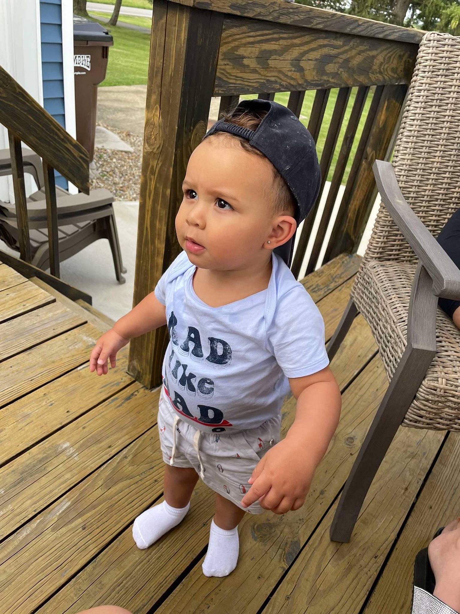Izaiah is registered to the contest to win money with this photo: baby, baby_toddler_clothing, composite_material, deck, flooring, foot, grass, hardwood, leisure, outdoor_furniture, person, plant, porch, shade, sitting, skin, sunglasses, thumb, toddler, wood
