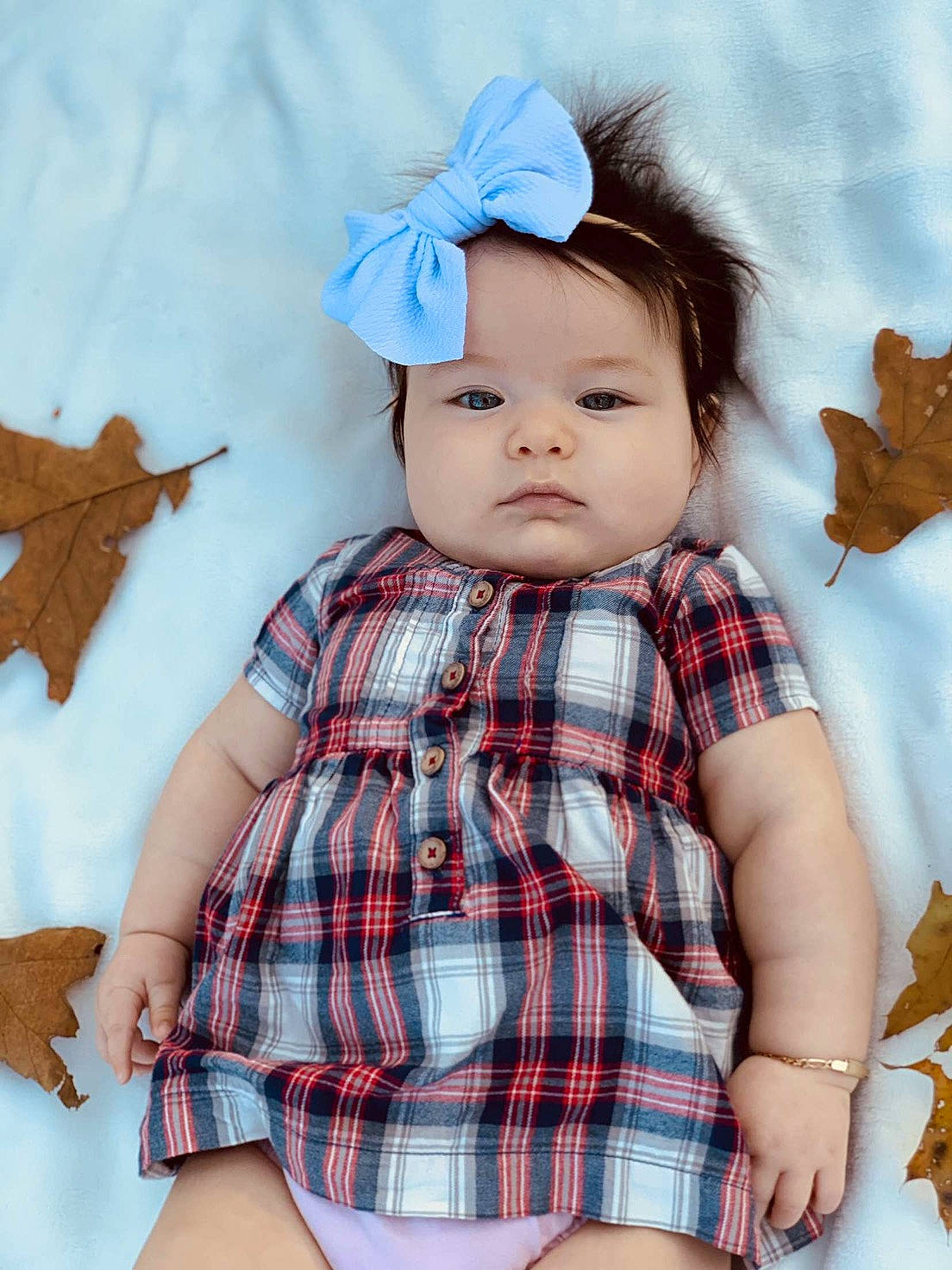 Leylah is registered to the contest to win money with this photo: baby_toddler_clothing, blue, doll, dress, eye, happy, head, headwear, iris, leaf, lip, pattern, person, pink, plaid, skin, sleeve, tartan, textile, toddler
