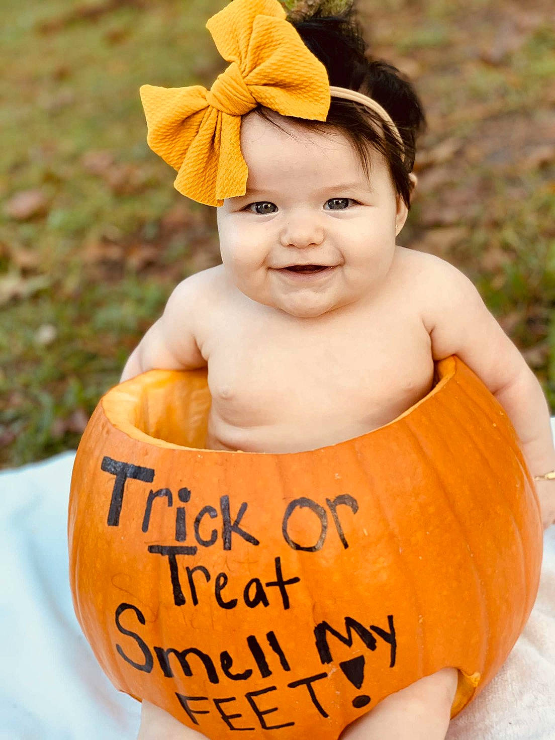 Leylah is registered to the contest to win money with this photo: baby, baby_toddler_clothing, calabaza, child, cucurbita, dress, face, fruit, grass, happy, head, headwear, joy, leaf, natural_foods, orange, people_in_nature, person, plant, pumpkin