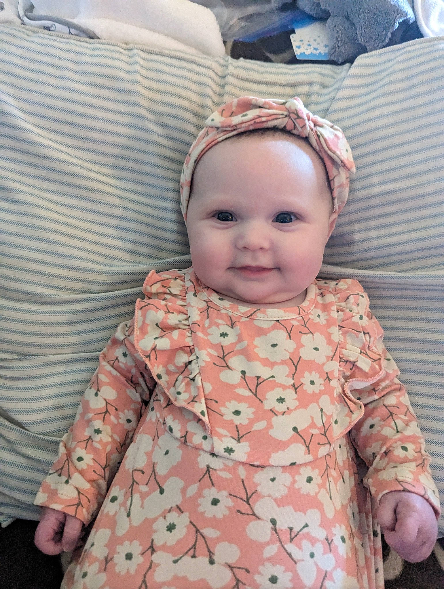 Kylee is registered to the contest to win money with this photo: baby, baby_toddler_clothing, cheek, child, collar, comfort, day_dress, eye, happy, iris, joy, linens, outerwear, pattern, peach, person, pink, plaid, skin, sleeve