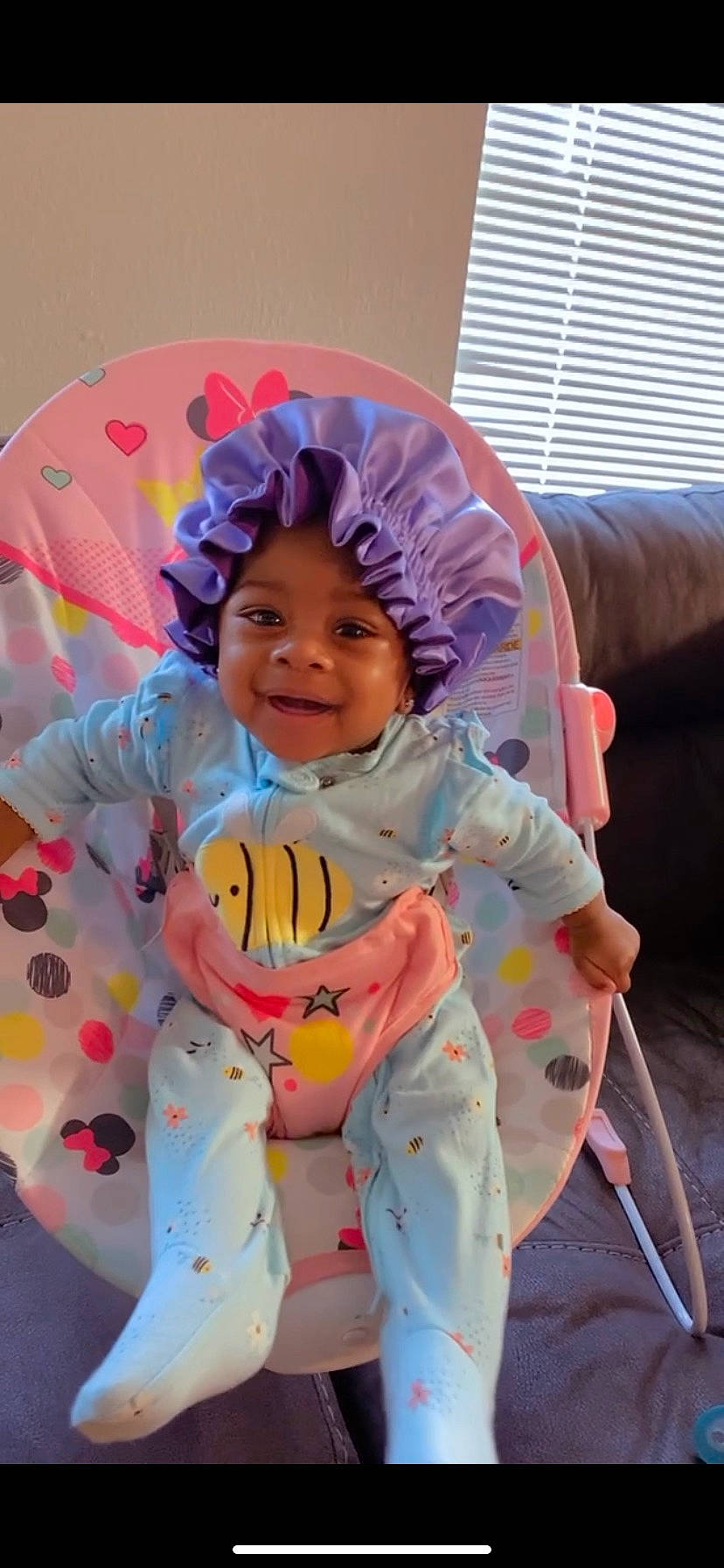 Jai Lani joined the competition — help win amazing prizes! baby, baby_products, baby_toddler_clothing, child, comfort, face, fun, happy, headwear, human_body, joy, linens, person, pink, purple, sitting, sleeve, smile, t_shirt, textile