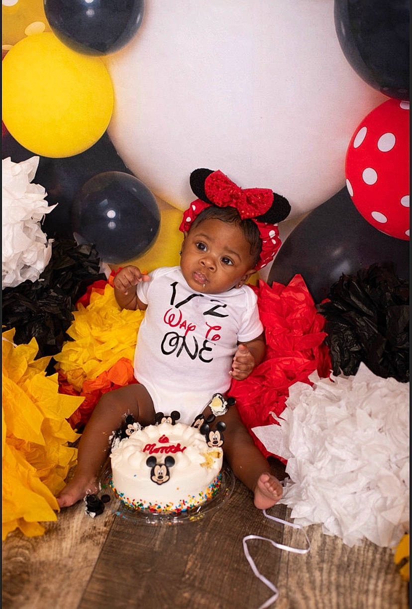 Jai Lani joined the competition — help win amazing prizes! baby, baby_toddler_clothing, balloon, birthday_cake, cake, cake_decorating, cake_decorating_supply, dessert, event, facial_expression, fun, happy, hat, orange, party_supply, people, person, red, sugar_cake, toddler