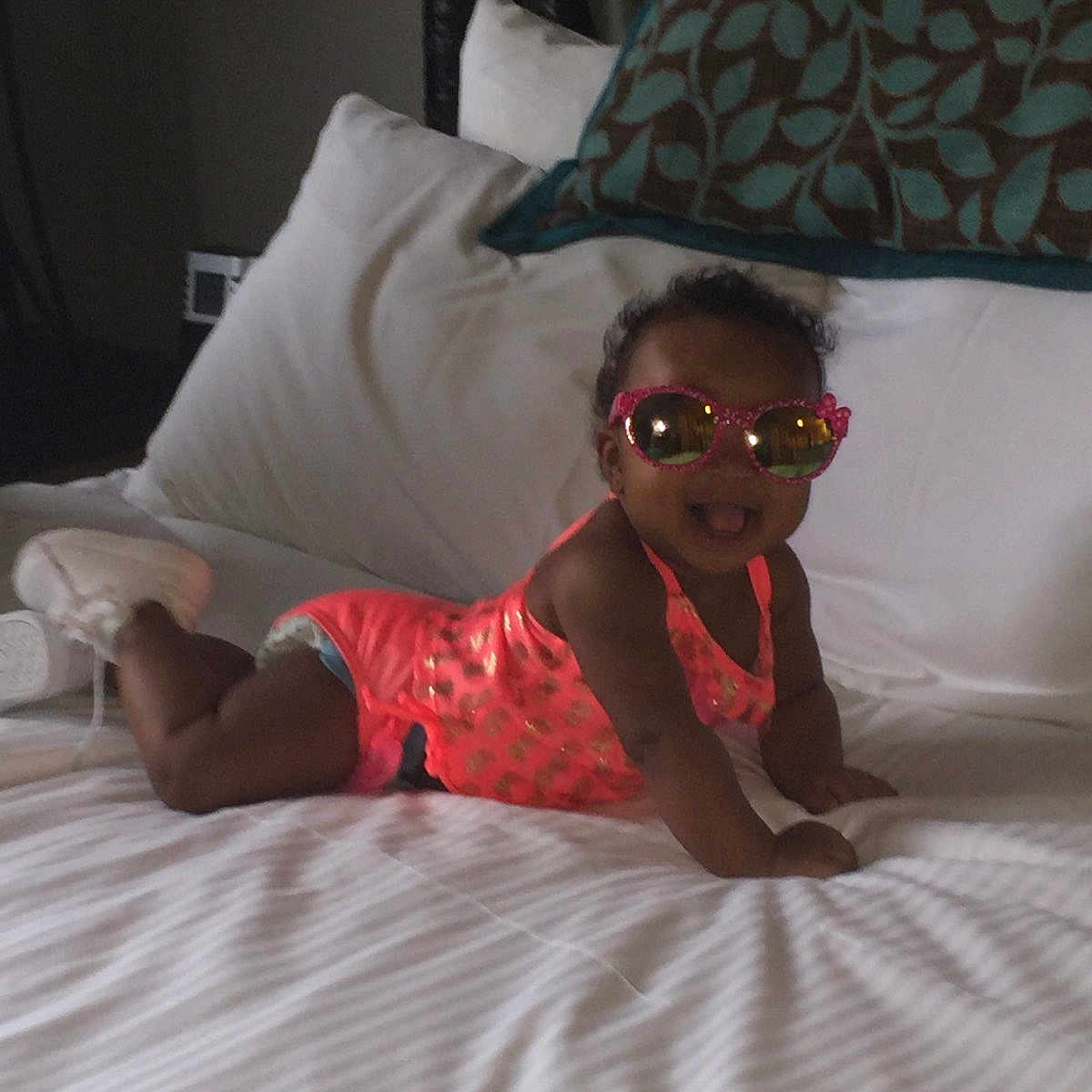 Alexandrea is registered to the contest to win money with this photo: baby, bed, bed_sheet, bedding, child, comfort, eyewear, fawn, finger, flooring, fun, glasses, leg, linens, room, sunglasses, textile, toddler, vacation