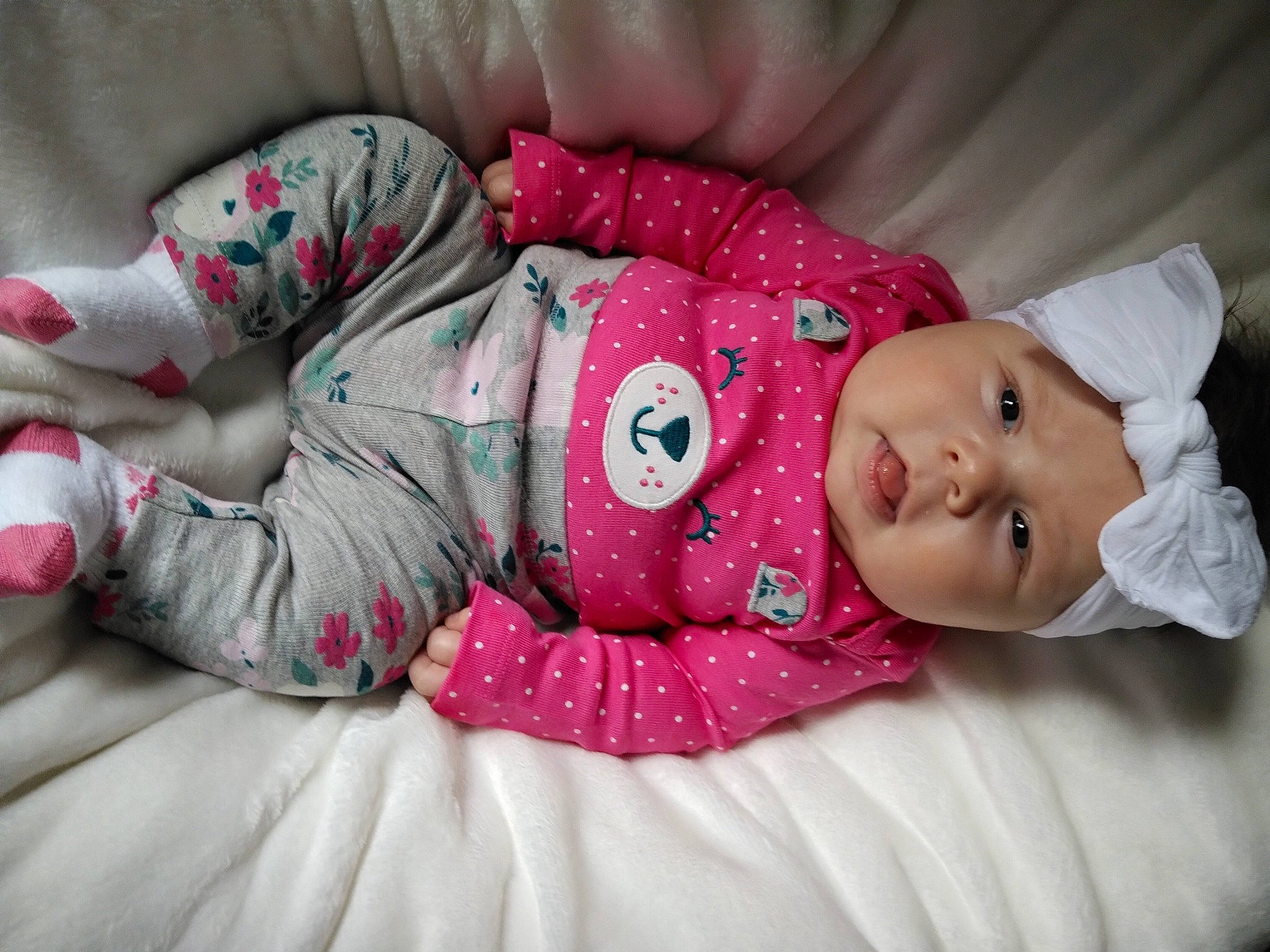 Jemma is registered to the contest to win money with this photo: arm, baby, baby_sleeping, baby_toddler_clothing, cheek, child, comfort, eye, facial_expression, hat, headgear, headwear, human_body, linens, mammal, person, pink, product, skin, sleeve