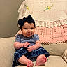 baby, smiling, bow, headband, blue_clothing, butterfly_pattern, sitting, armchair, blanket, crochet, embroidery, feet, hands, happy, indoors, cozy, cute, child, portrait, fabric