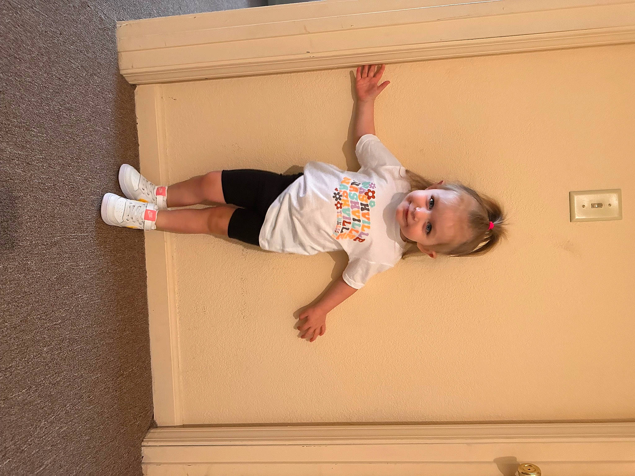 Bexley is registered to the contest to win money with this photo: balance, child, comfort, elbow, flooring, fun, hardwood, human_body, human_leg, joy, knee, outdoor_shoe, person, room, shorts, smile, t_shirt, thigh, toddler, walking_shoe