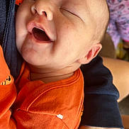 Oliver joined the competition — help win amazing prizes! baby, infant, smiling, face, skin, orange_clothing, child, person, closeup, sleeping, hand, arm, texture, fabric, comfort, peaceful, cute, young, portrait, toddler
