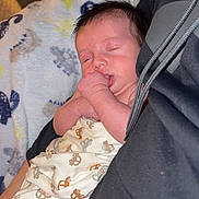 Ryker is registered to the contest to win money with this photo: baby, sleeping, blanket, car_pattern, thumb_sucking, infant, cozy, indoor, person, child, cute, resting, soft_fabric, comfort, newborn, portrait, wrapped, peaceful, relaxation, clothing