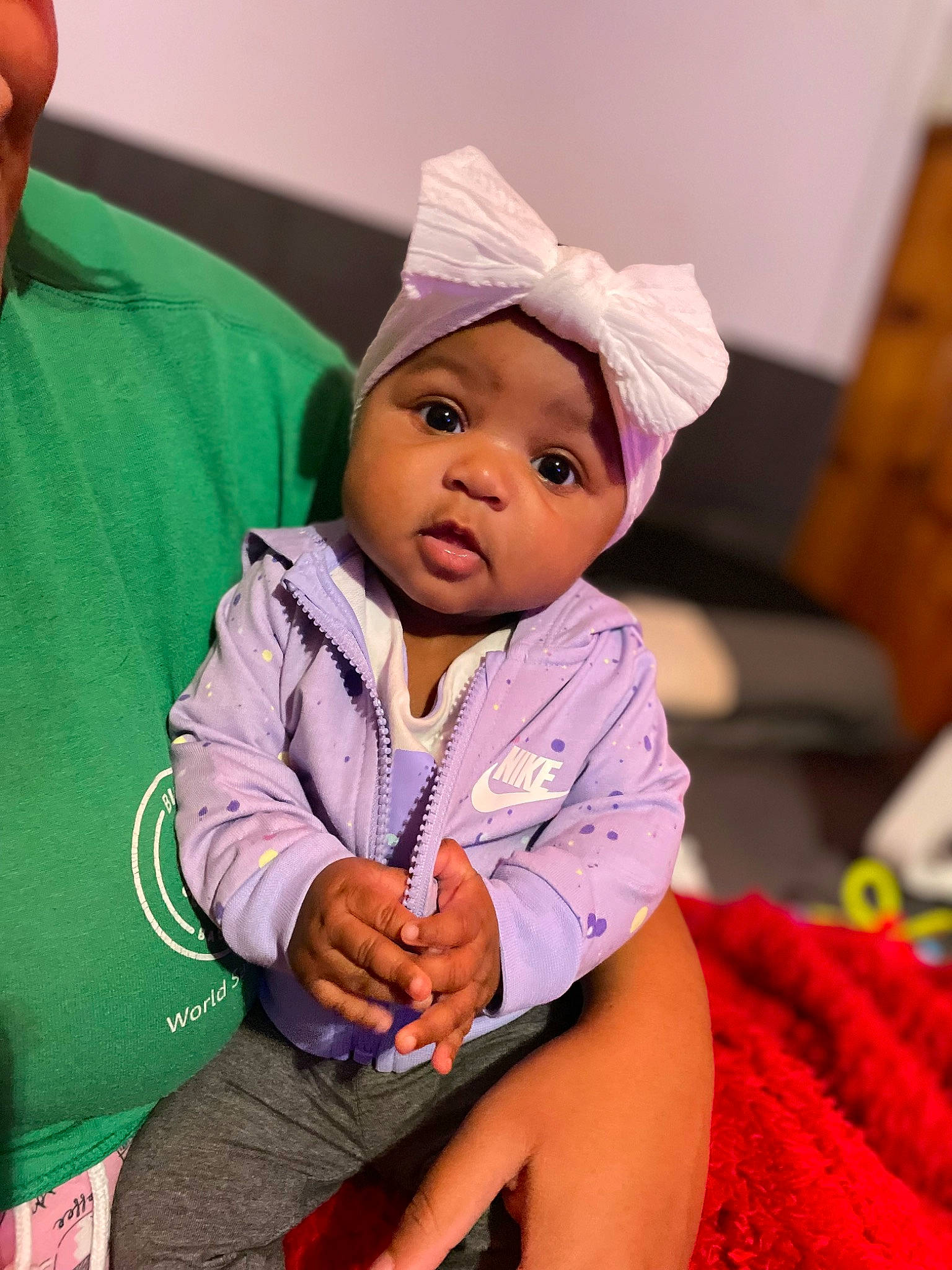 Zyaira is registered to the contest to win money with this photo: baby, baby_toddler_clothing, beanie, bonnet, cap, cheek, child, comfort, costume_hat, fashion_accessory, fun, happy, headwear, holiday, magenta, person, pink, portrait_photography, room, sitting