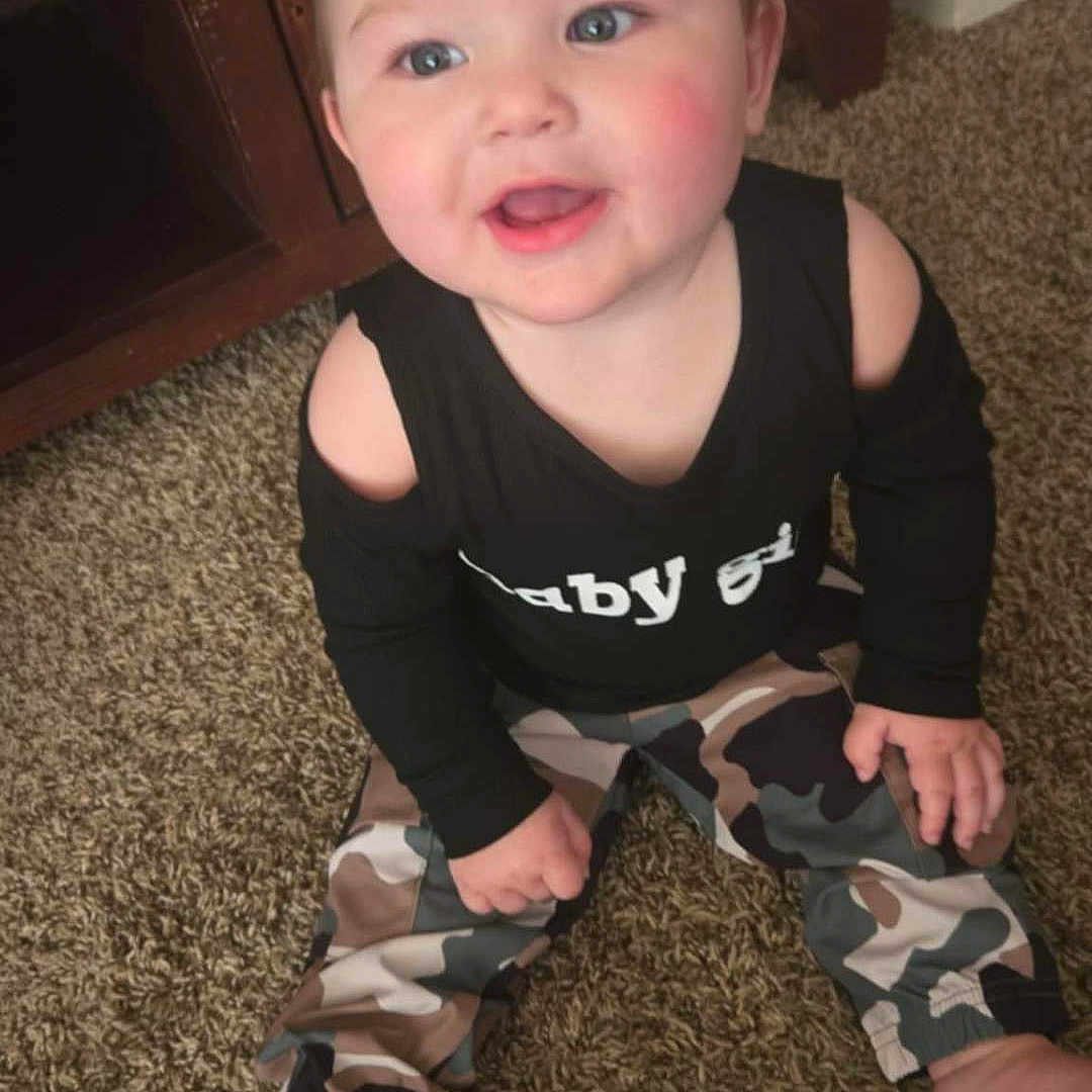 Scarlett is registered to the contest to win money with this photo: baby, bodypart, clothing, costume, crawling, dress, face, happy, head, jeans, laughing, mouth, pants, person, photography, portrait, shorts, sitting, t_shirt, teeth