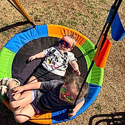 Titus is registered to the contest to win money with this photo: child, children, swing, playground, outdoor, grass, sunglasses, tshirt, baby, toddler, summer, sunny, play, fun, colorful, toy, happy, person, casual, relax