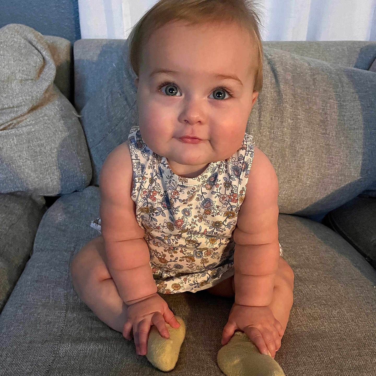 Liv is registered to the contest to win money with this photo: architecture, baby, building, clothing, couch, cushion, face, furniture, head, homedecor, hosiery, indoors, livingroom, pants, person, photography, portrait, room, sitting, sock