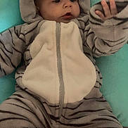 Alessio participe au concours pour gagner de l'argent avec cette photo : baby, child, infant, onesie, tiger_stripes, hood, ears, cushion, soft, cozy, hand, curious, lying_down, cute, clothing, warm, indoor, portrait, expression, comfortable