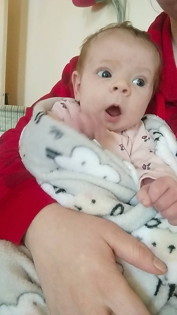 Oaklynn is registered to the contest to win money with this photo: baby, baby_toddler_clothing, cheek, child, comfort, eye, eyebrow, finger, hand, happy, human_body, iris, linens, nail, nose, person, sitting, skin, sleeve, surprise