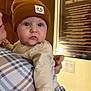 Asher joined the competition — help win amazing prizes! adult, baby, beanie, child, clothing, cozy, curious, expression, face, hand, hat, holding, indoor, person, plaid, plush, portrait, shirt, warm_lighting, wide_eyes