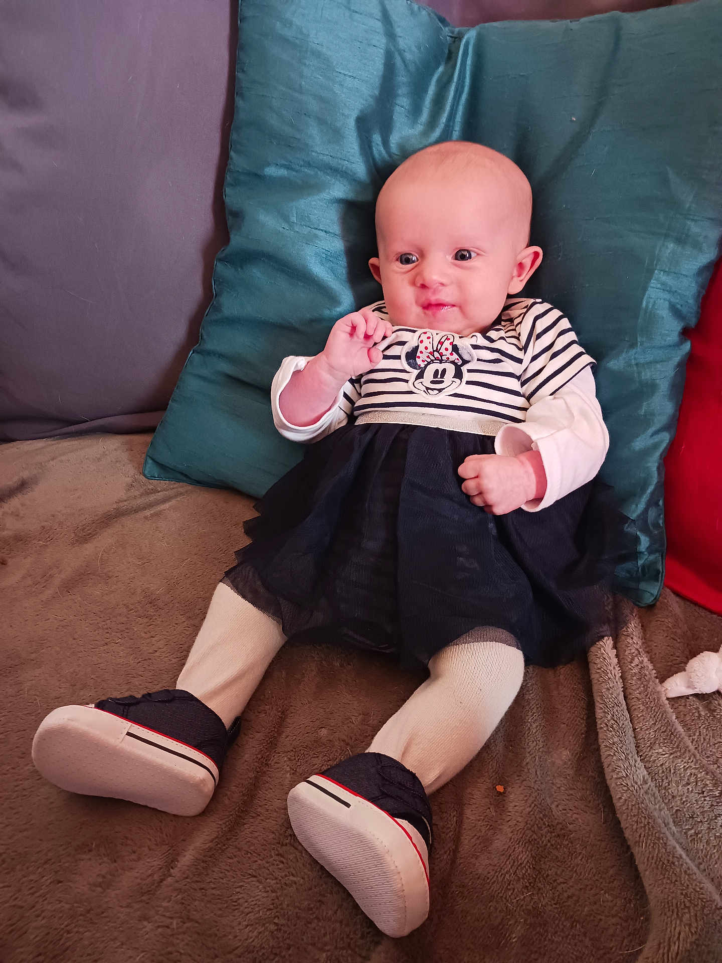 Ophélie participe au concours pour gagner de l'argent avec cette photo : baby, infant, child, couch, pillow, clothing, dress, tights, shoes, striped, sitting, smiling, cute, indoor, soft, comfortable, person, portrait, young, home