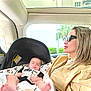 Valentino joined the competition — help win amazing prizes! baby, woman, car, car_seat, sleeping, sunglasses, hand, jacket, seat, window, sunroof, building, greenery, roadside, portrait, interior, travel, child, person, relaxing