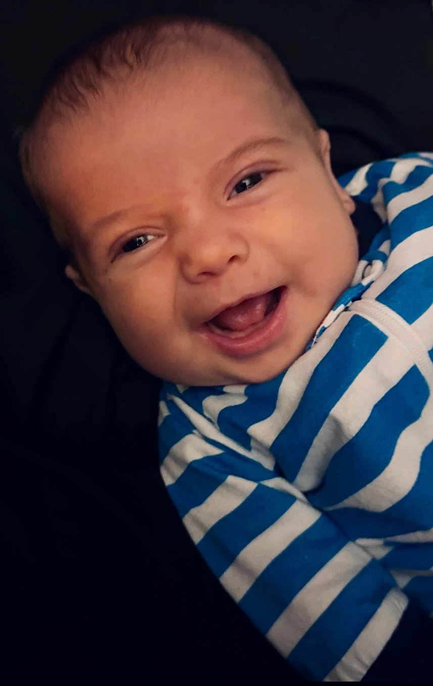 Ronin is registered to the contest to win money with this photo: baby, smiling, face, child, blue_stripes, striped_clothing, infant, portrait, happy, cute, young_child, apparel, closeup, person, wearing, head, skin, eyes, mouth, baby_clothes