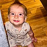 baby, child, smiling, mohawk, sitting, wooden_floor, indoors, cute, happy, face, person, clothing, couch, eyes, skin, hair, expression, infant, one_person, portrait