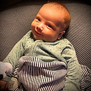 Ronin joined the competition — help win amazing prizes! baby, smiling, blanket, striped_blanket, baby_clothing, infant, face, portrait, lying_down, cozy, soft_light, cute, child, pacifier, hand, texture, fabric, indoor, warm, young_child
