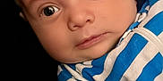 Ronin joined the competition — help win amazing prizes! baby, infant, face, portrait, blue_striped_clothing, close_up, eyes, expression, skin, head, person, newborn, cute, child, young, clothing, striped, looking, indoors, human