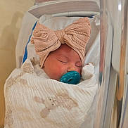 Nora is registered to the contest to win money with this photo: baby, bassinet, blanket, bow, child, cozy, cute, face, headband, hospital, infant, newborn, nursery, pacifier, peaceful, resting, sleeping, soft, toddler, wrapped