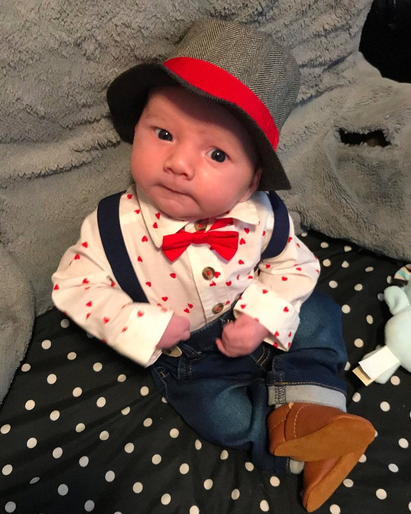 Eastan is registered to the contest to win money with this photo: baby, baby_toddler_clothing, cap, child, collar, dress, dress_shirt, face, formal_wear, happy, headwear, outerwear, pattern, person, plaid, skin, sleeve, suit, tartan, textile