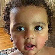 Amir joined the competition — help win amazing prizes! toddler, child, face, curly_hair, indoors, closeup, portrait, expression, cute, skin, mouth, eyes, person, young_child, curiosity, hair, head, baby, innocence, background
